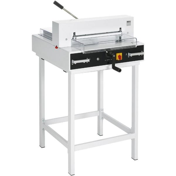 A white electric guillotine with a manual clamp, transparent safety guards, and a digital measurement readout, mounted on a white stand.