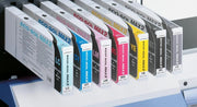 Set of ink cartridges with labels on a printer bed