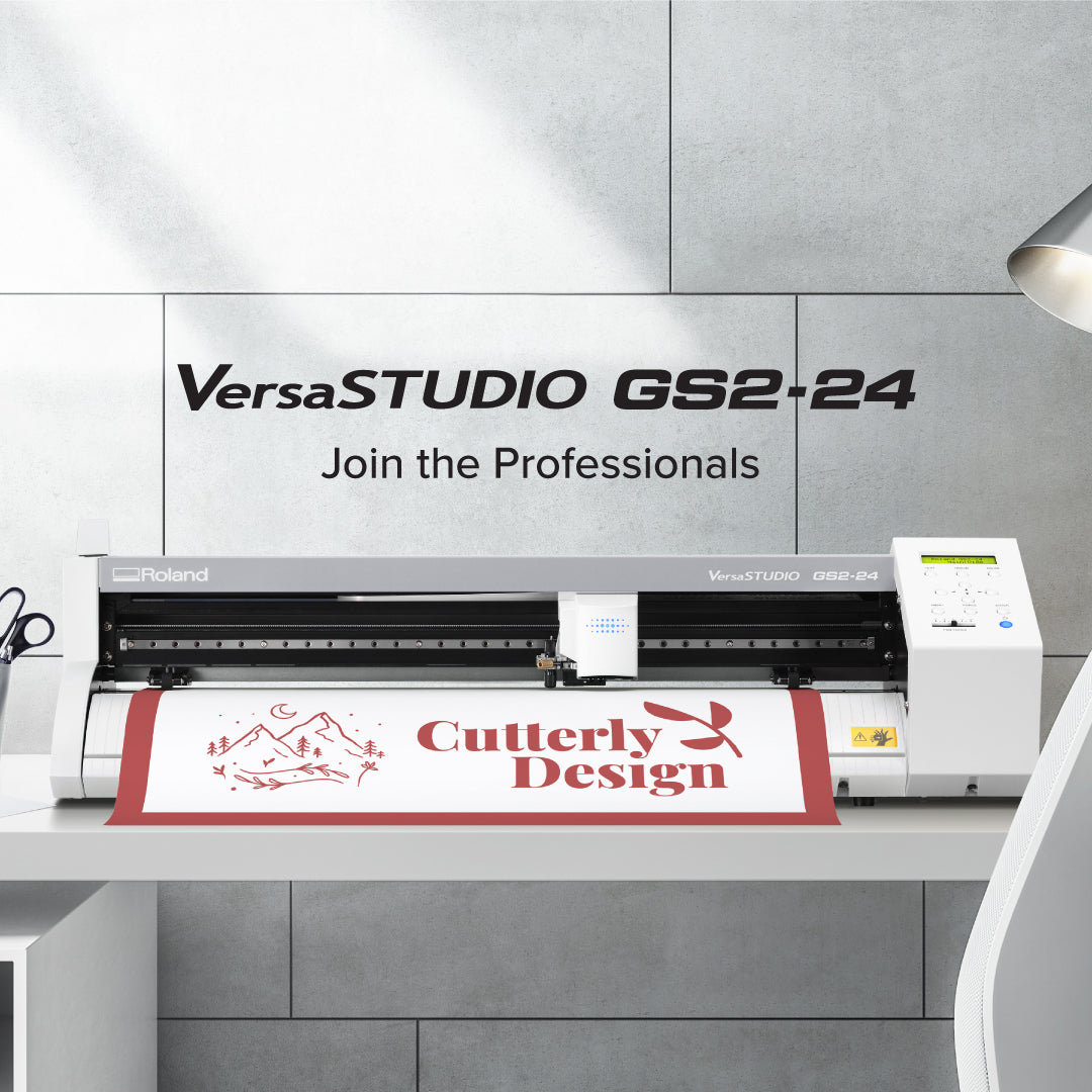 Roland VersaSTUDIO GS2-24 digital printing machine with a printed banner displaying 'Gutterly Design' on a gray tiled wall background.