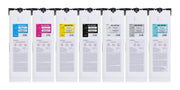 Seven white hanging pouches or sheets arranged side by side on a black rail, each with a different colored label card (cyan, magenta, yellow, black, white, gray, and light blue) and printed text and hazard symbols.