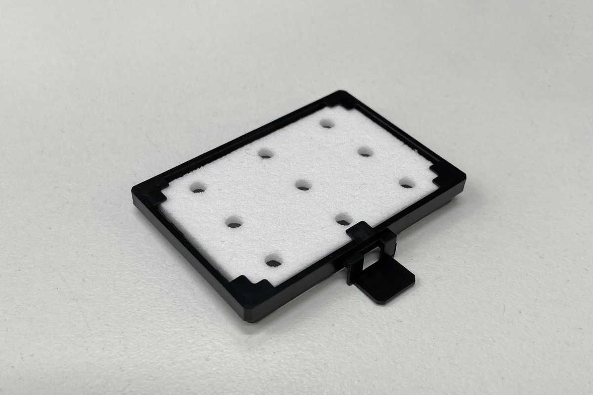 A black and white Mutoh Flushing Pad for XpertJet and ValueJet wide format printers.