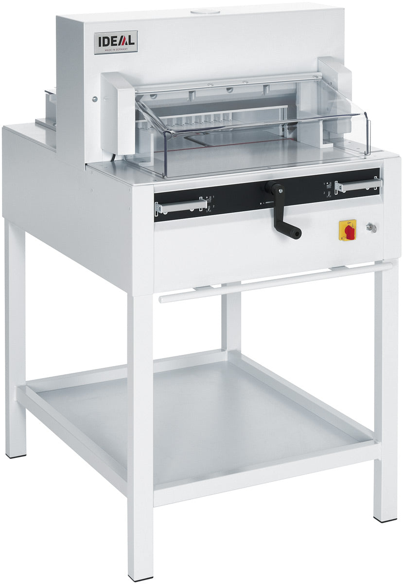 A white IDEAL 4850 electric guillotine with a transparent safety guard and a hand crank, designed for paper folding and cutting.